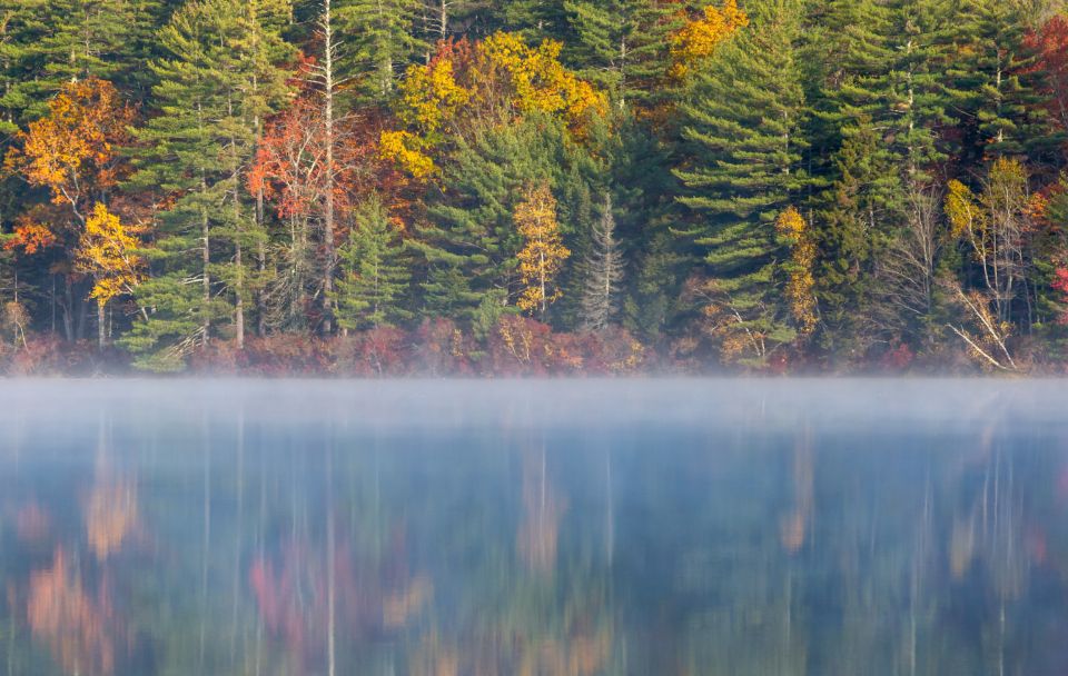 The lake, still, with hills behind
